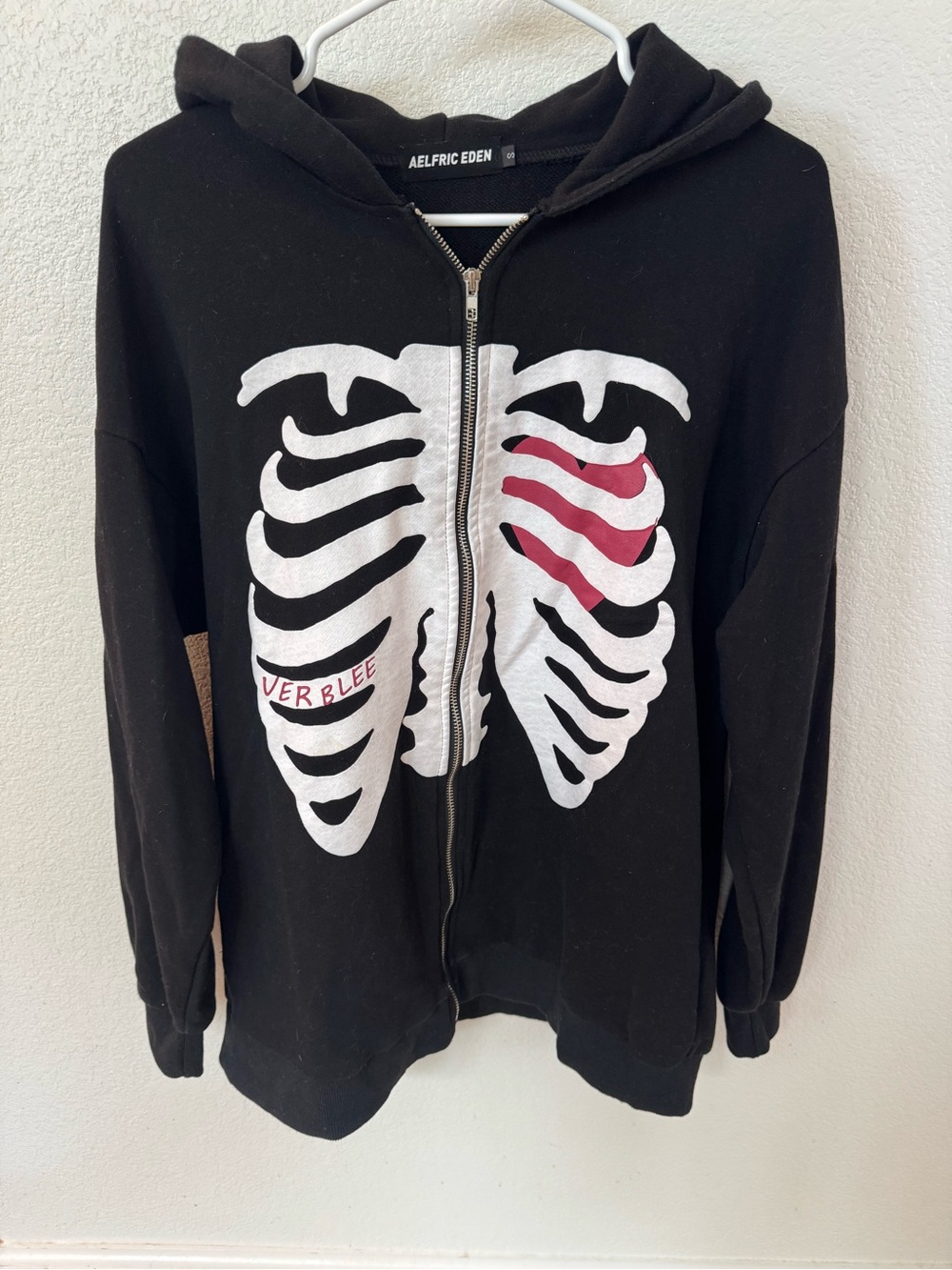 Aelfric Eden Black Zip Hoodie with White Rib Cage and Red Accent
